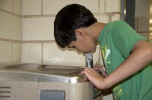 Child drinks from a fountain